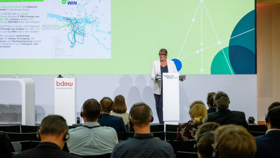 eine Frau hält einen Impulsvortrag im Plenum auf dem Treffpunkt Netze 2023
